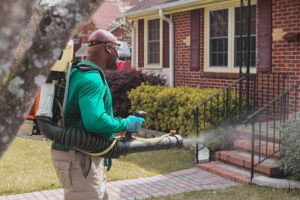 Mosquito control specialist treating a customer's yard